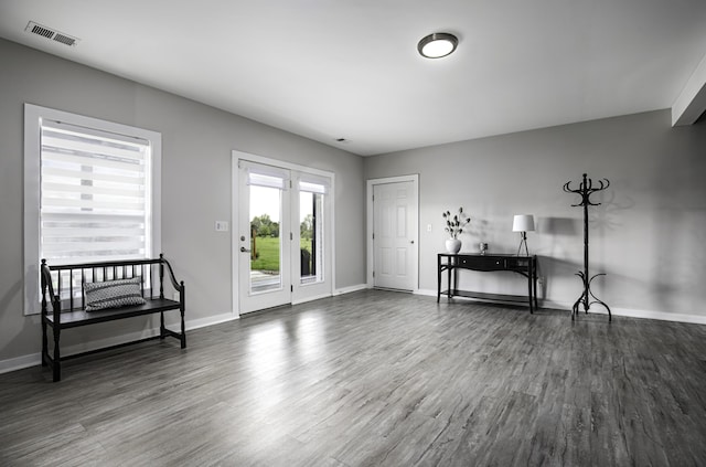 entrance foyer with dark wood-type flooring and baseboards