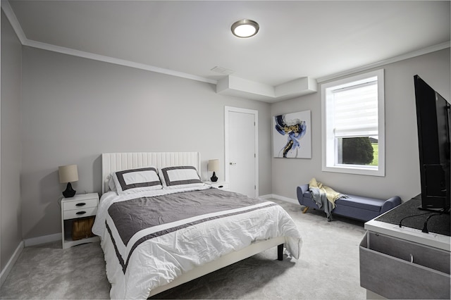 carpeted bedroom with ornamental molding and baseboards