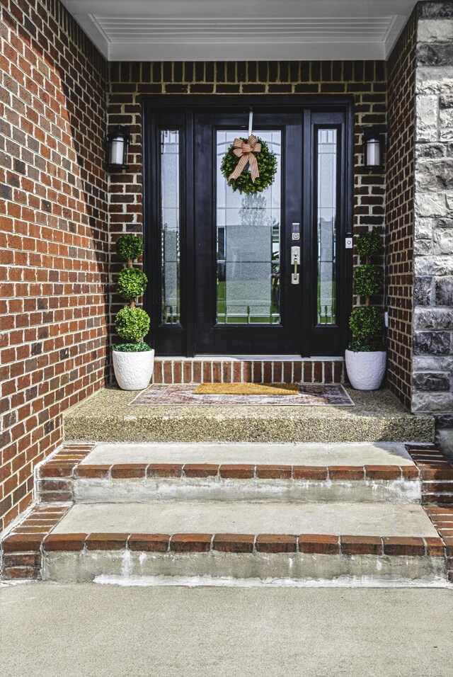 entrance to property with brick siding