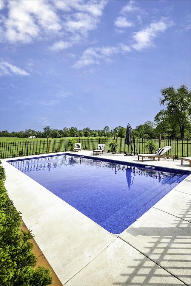view of swimming pool featuring fence and a patio area