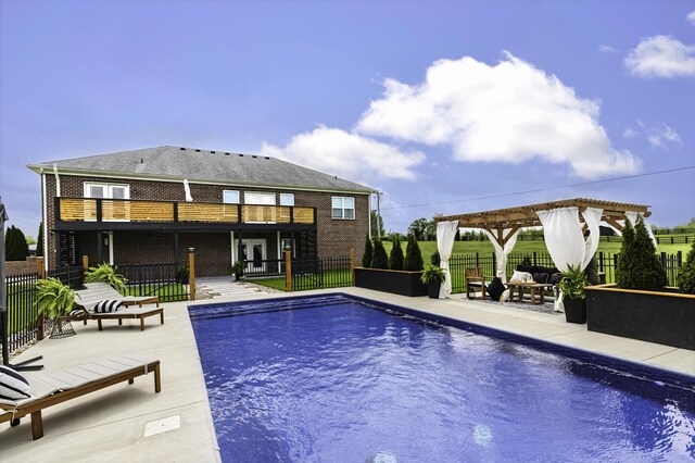 view of pool with a pergola, a patio area, and fence