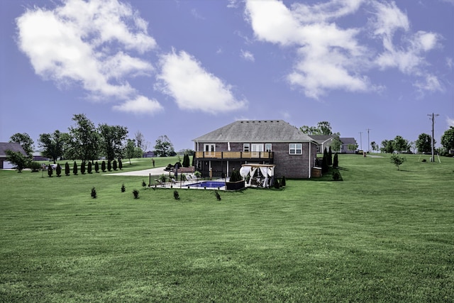view of community with a yard, a pool, and a wooden deck