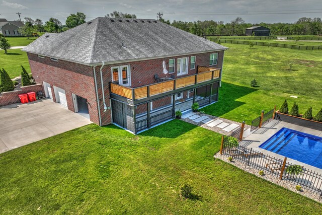 101 Creek Ridge Dr, Nicholasville, KY 40356 - rear view of house with roof with shingles, an attached garage, brick siding, concrete driveway, and an outdoor pool