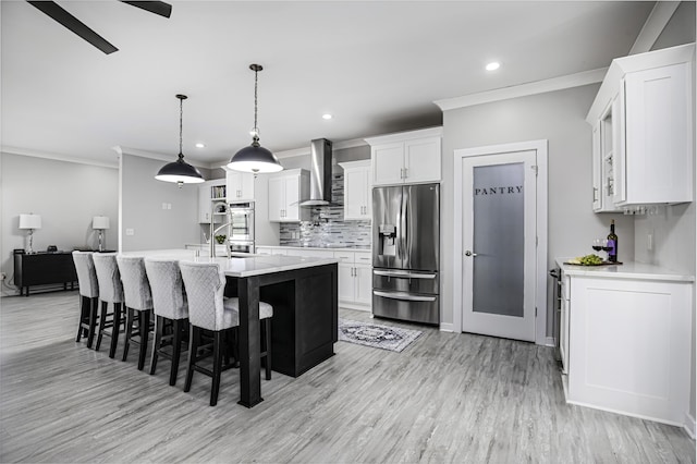 101 Creek Ridge Dr, Nicholasville, KY 40356 - kitchen with stainless steel appliances, wall chimney exhaust hood, ornamental molding, light countertops, and white cabinets