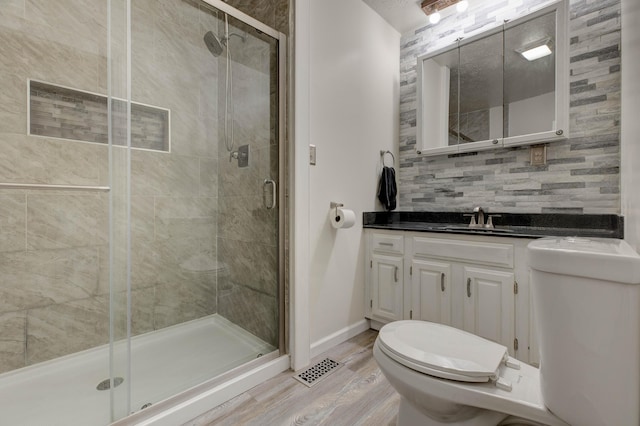 246 Pottersville Rd, Means, KY 40346 - bathroom featuring toilet, a stall shower, decorative backsplash, and wood finished floors