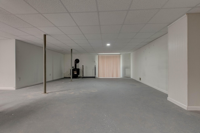 246 Pottersville Rd, Means, KY 40346 - finished basement featuring a wood stove, baseboards, a paneled ceiling, and recessed lighting