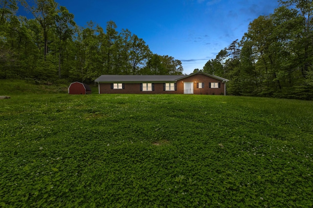 246 Pottersville Rd, Means, KY 40346 - view of front of house featuring a storage shed, brick siding, an outdoor structure, and a front yard