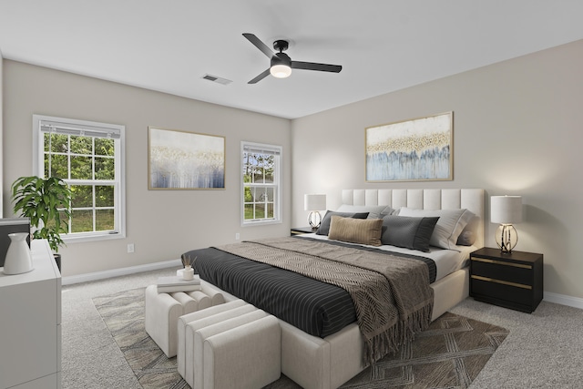 carpeted bedroom with baseboards and a ceiling fan