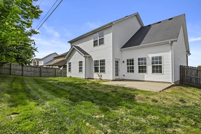 rear view of property with a patio and a shingled roof