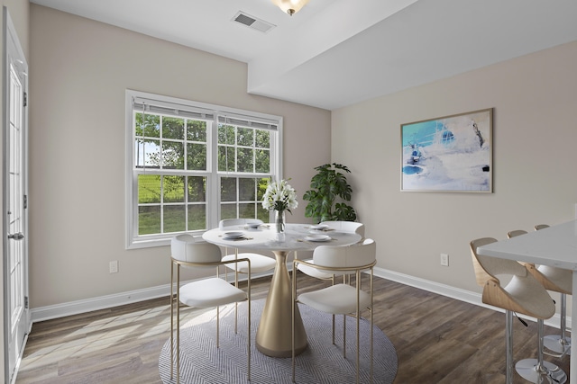 dining room with baseboards and wood finished floors