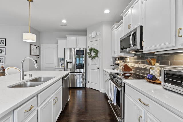 468 Lucille Dr, Lexington, KY 40511 - kitchen featuring appliances with stainless steel finishes, a sink, white cabinetry, decorative backsplash, and light stone counters