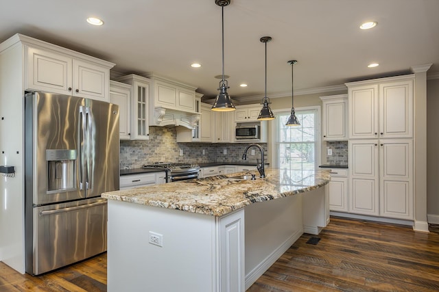 kitchen with appliances with stainless steel finishes, a sink, white cabinetry, backsplash, and ornamental molding