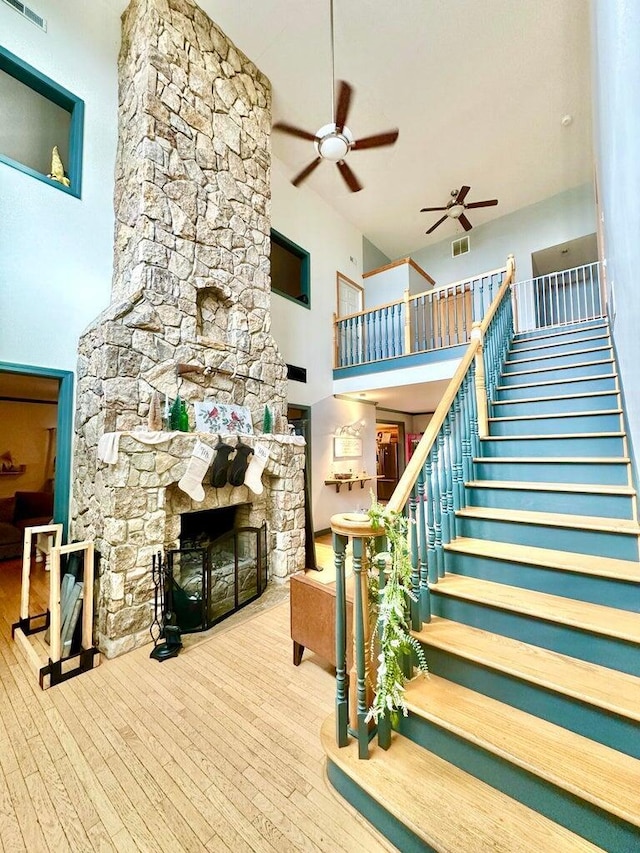 80 Jackson Rd, Somerset, KY 42503 - interior space featuring hardwood / wood-style flooring, stairway, a ceiling fan, a high ceiling, and a stone fireplace