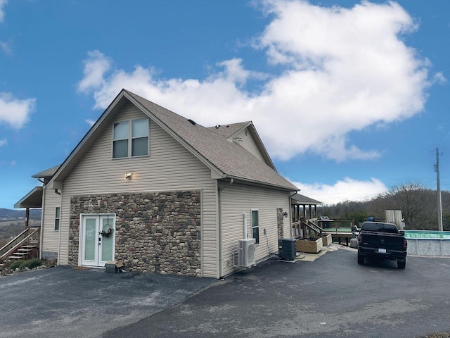 80 Jackson Rd, Somerset, KY 42503 - view of side of home with stone siding, roof with shingles, cooling unit, and stairway