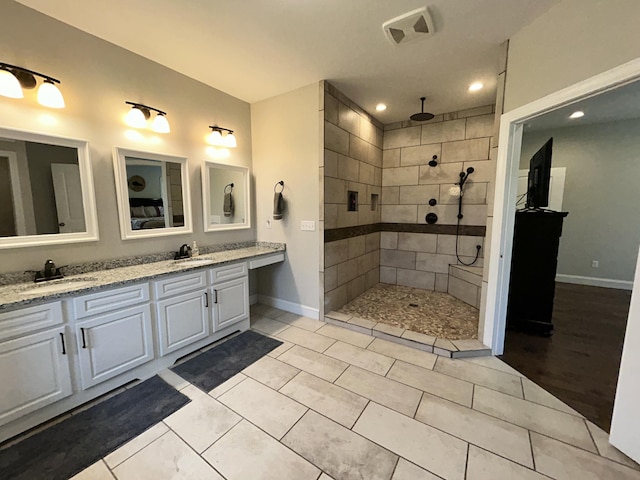 111 Fern Dr, Somerset, KY 42501 - bathroom featuring a sink, double vanity, baseboards, and tiled shower