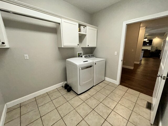 111 Fern Dr, Somerset, KY 42501 - laundry room featuring washing machine and clothes dryer, baseboards, light tile patterned floors, and cabinet space