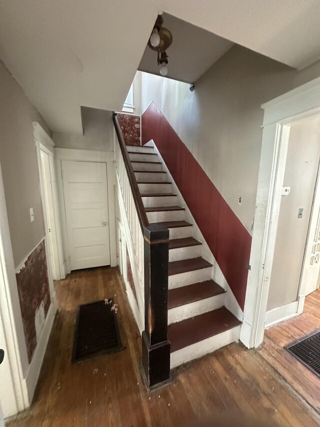 stairway with hardwood / wood-style flooring