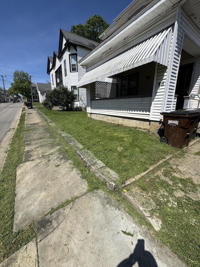 view of property exterior featuring a lawn