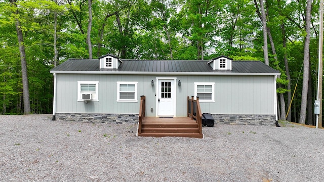 cape cod-style house featuring cooling unit and metal roof