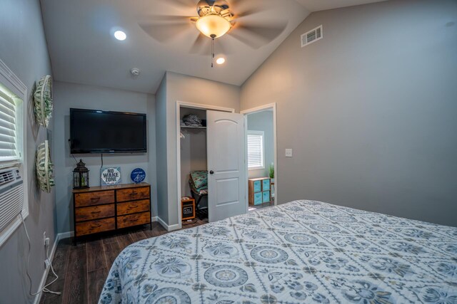bedroom with a closet, visible vents, baseboards, dark wood-type flooring, and vaulted ceiling