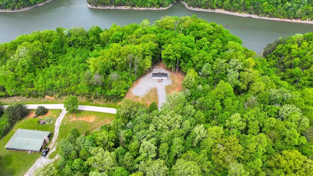 aerial view with a water view and a wooded view