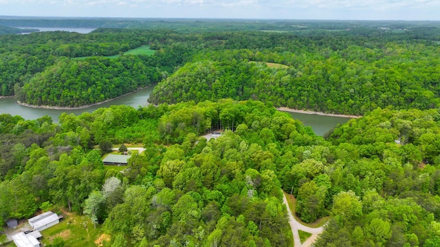 aerial view with a water view and a wooded view