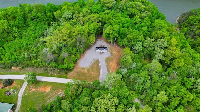 birds eye view of property featuring a wooded view