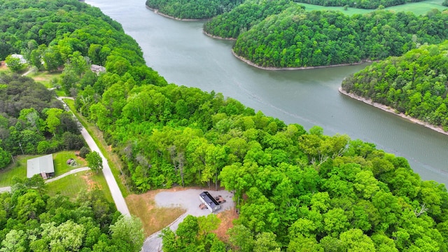 drone / aerial view with a water view and a wooded view