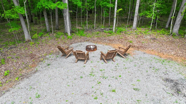 view of yard featuring an outdoor fire pit