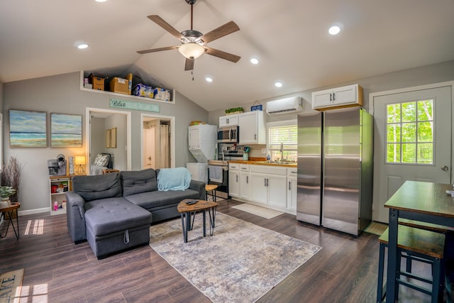 living area featuring lofted ceiling, dark wood finished floors, recessed lighting, a wall mounted AC, and a ceiling fan
