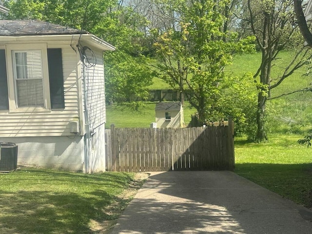 225 Mt Sterling Ave, Flemingsburg, KY 41041 - view of side of home with fence, central AC, and a lawn