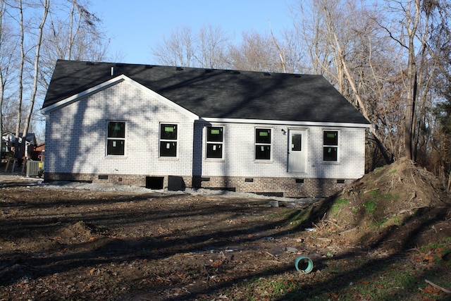view of front of property featuring crawl space, brick siding, and roof with shingles