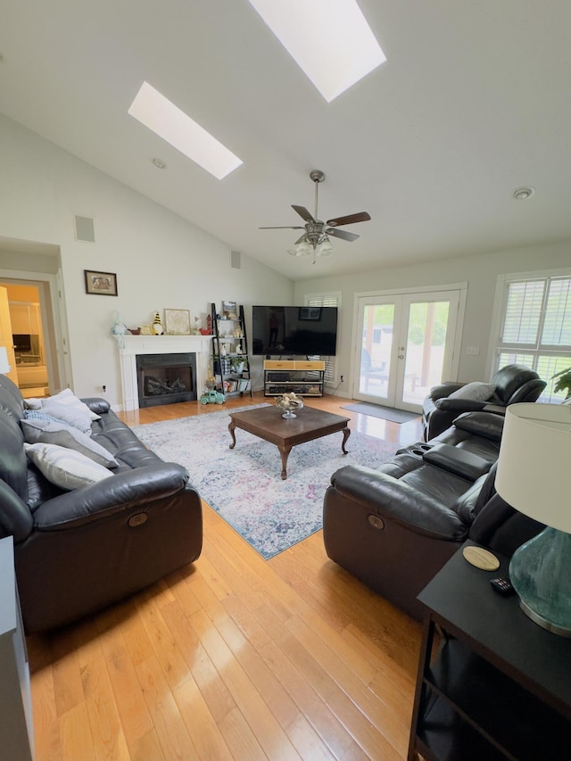 100 Dillon Ct, Berea, KY 40403 - living area with vaulted ceiling with skylight, wood finished floors, visible vents, a fireplace, and a ceiling fan