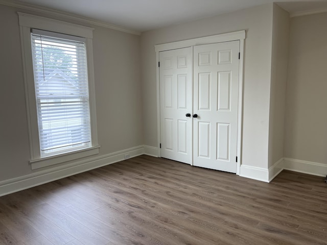 211 S Alta Ave, Danville, KY 40422 - unfurnished bedroom featuring ornamental molding, wood finished floors, and a closet