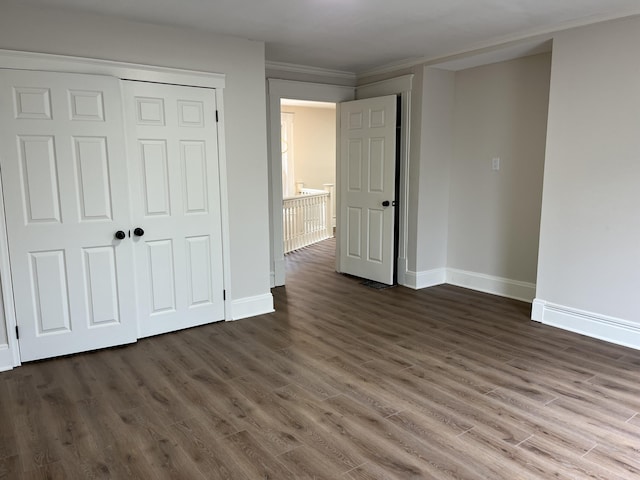 211 S Alta Ave, Danville, KY 40422 - unfurnished bedroom with dark wood-type flooring, a closet, and ornamental molding