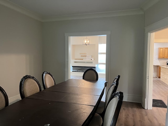 211 S Alta Ave, Danville, KY 40422 - dining space with a chandelier, wood finished floors, and crown molding