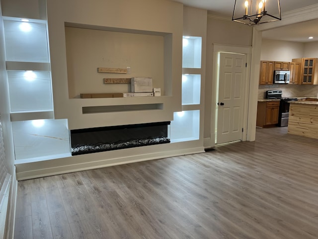 211 S Alta Ave, Danville, KY 40422 - unfurnished living room with wood finished floors, a chandelier, and ornamental molding