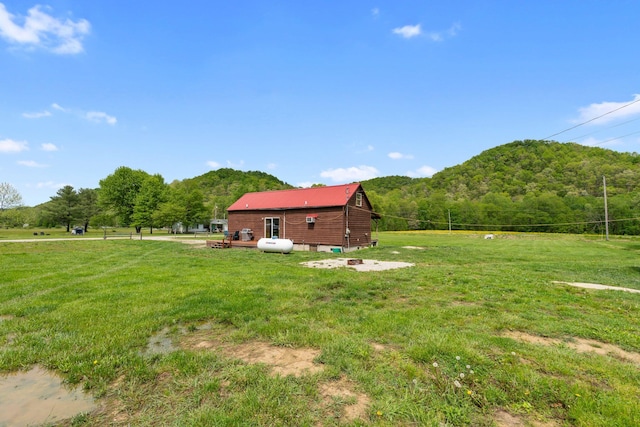 view of yard with a mountain view and a wooded view
