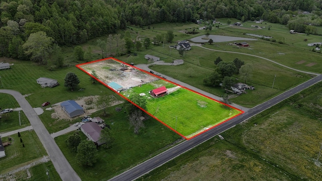 birds eye view of property with a forest view