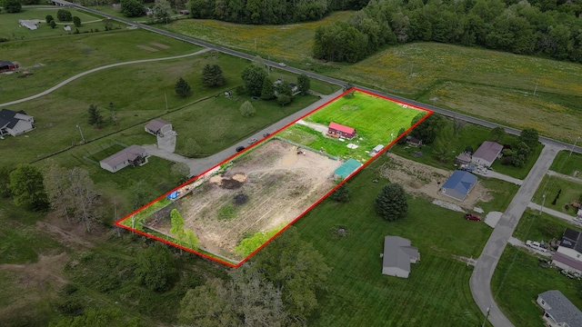 birds eye view of property with a rural view