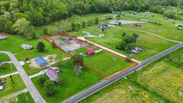 drone / aerial view with a wooded view