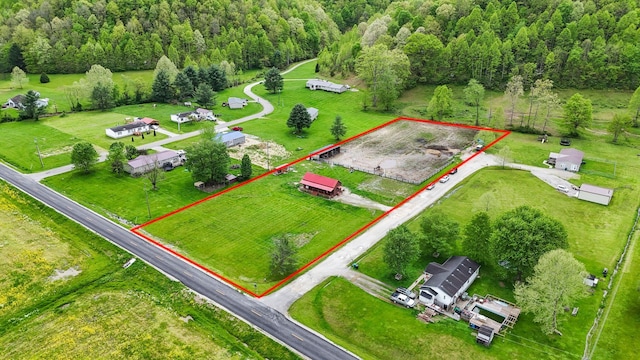 birds eye view of property featuring a wooded view