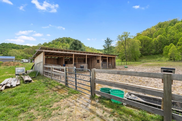 view of stable with a view of trees