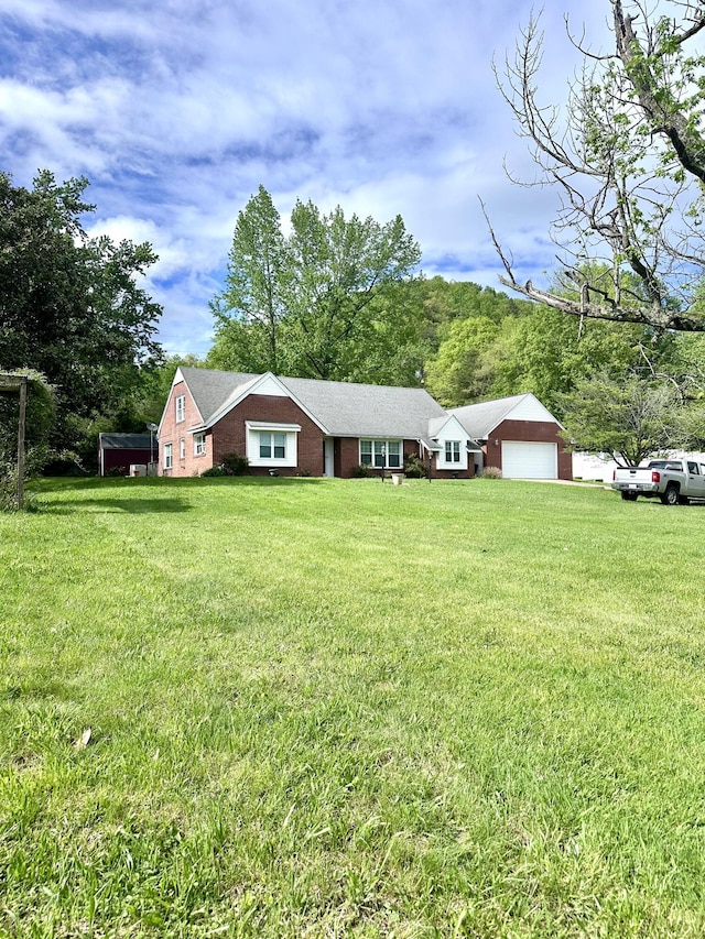 single story home with a front yard and a garage