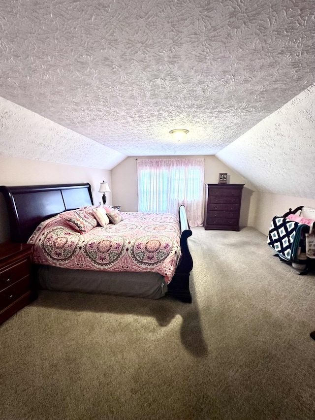 bedroom with a textured ceiling, carpet, and vaulted ceiling