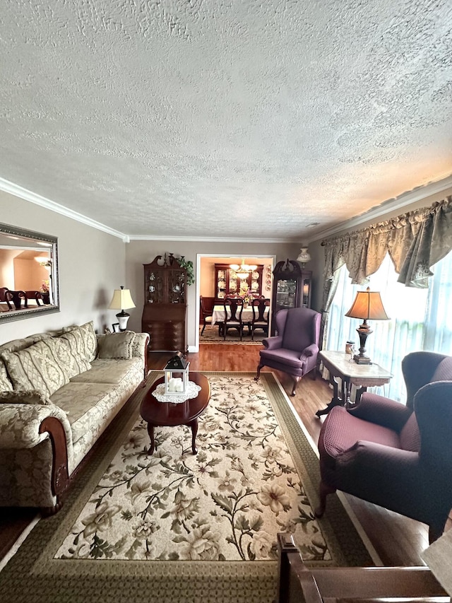 living area featuring crown molding, a textured ceiling, wood finished floors, and a notable chandelier