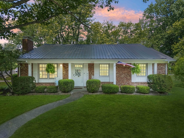 202 Leimaur Dr, Richmond, KY 40475 - view of front facade featuring a front lawn, metal roof, and a chimney