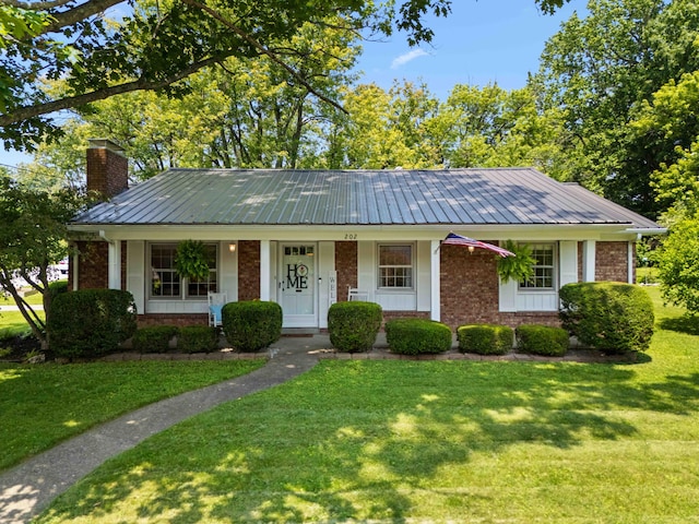 202 Leimaur Dr, Richmond, KY 40475 - view of front of house featuring brick siding, metal roof, a chimney, and a front lawn