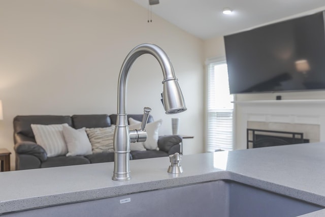 1208 Four Wynds Trl, Lexington, KY 40515 - detailed view of a sink, light stone countertops, a fireplace, and a ceiling fan