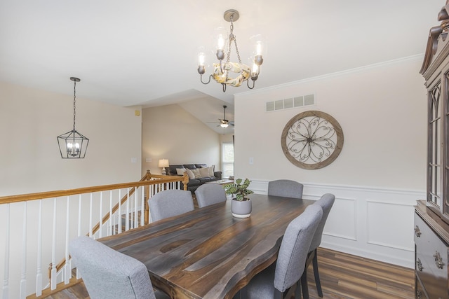 1208 Four Wynds Trl, Lexington, KY 40515 - dining room featuring a chandelier, dark wood-type flooring, wainscoting, a ceiling fan, and vaulted ceiling